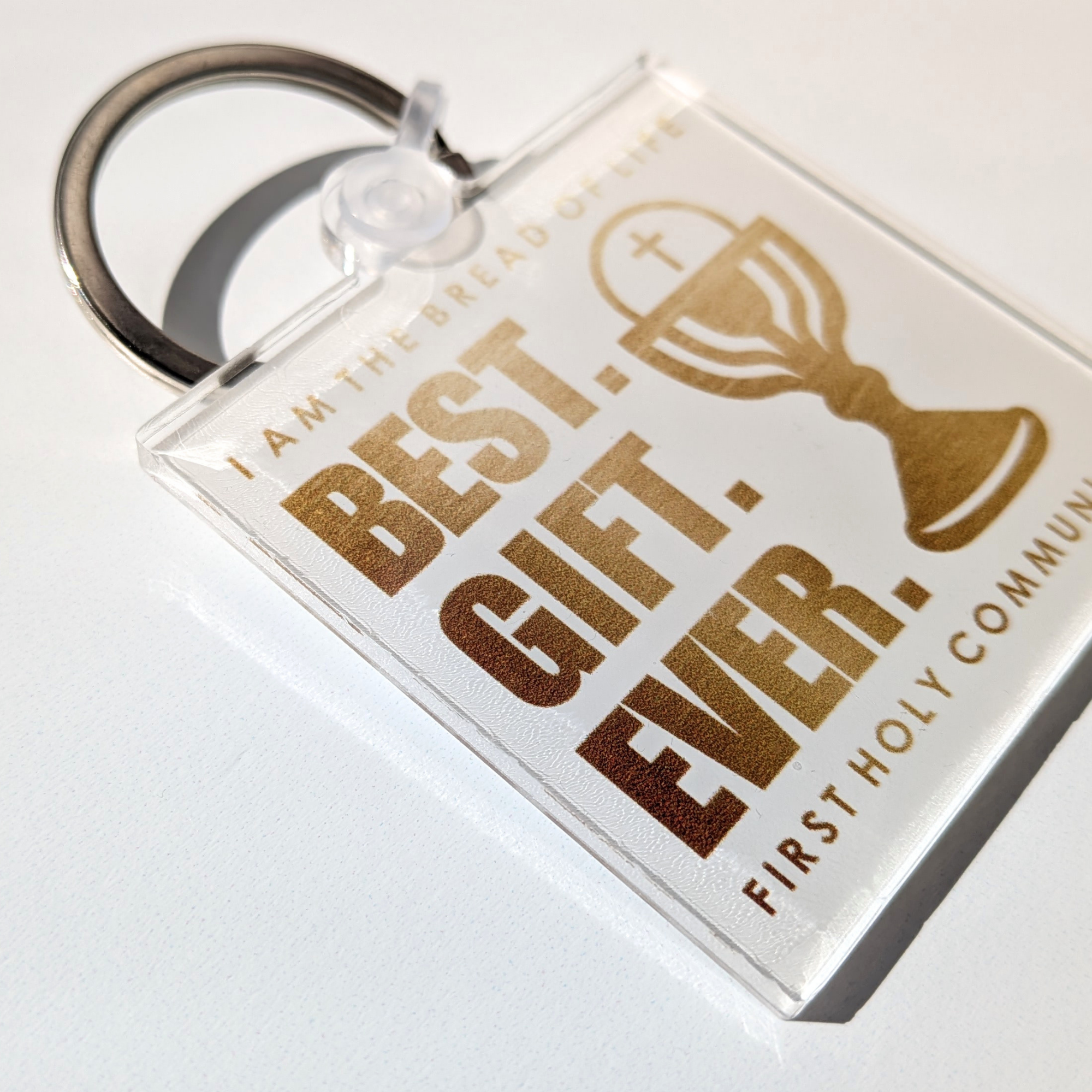 Keychain with 'Best Gift Ever' text and First Holy Communion design on a white background