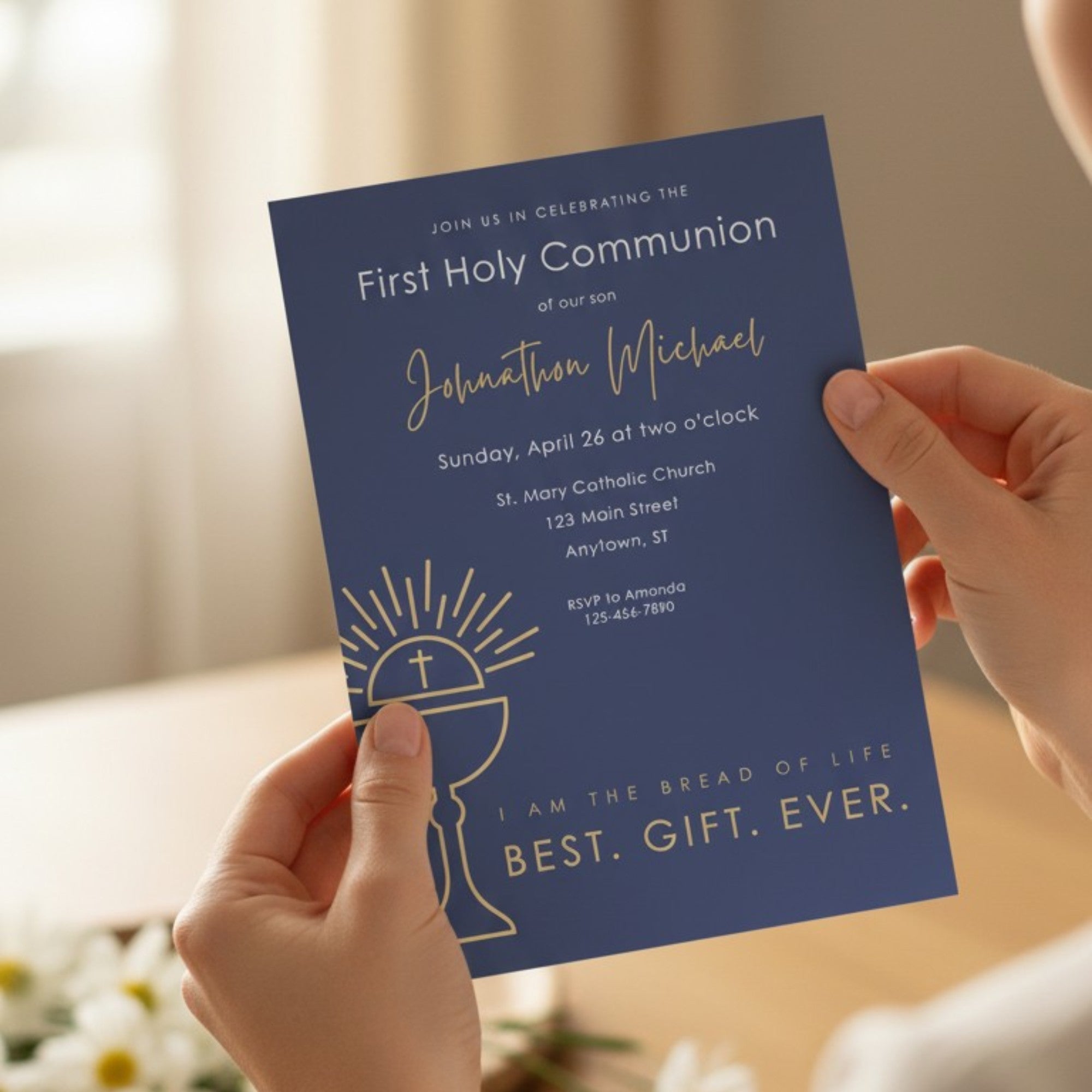 Hands holding a blue First Holy Communion invitation card with white text.