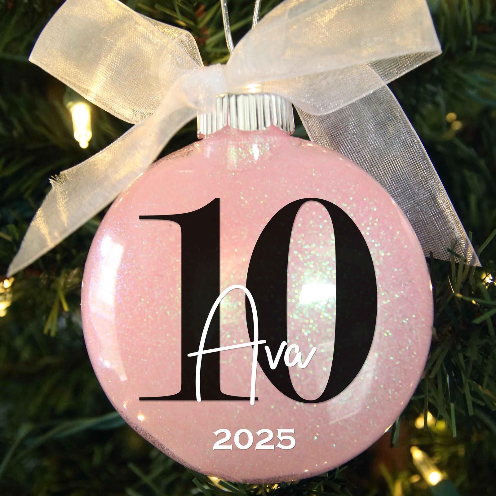 10 birthday ornament personalized with a name and year, and featured in light pink glitter