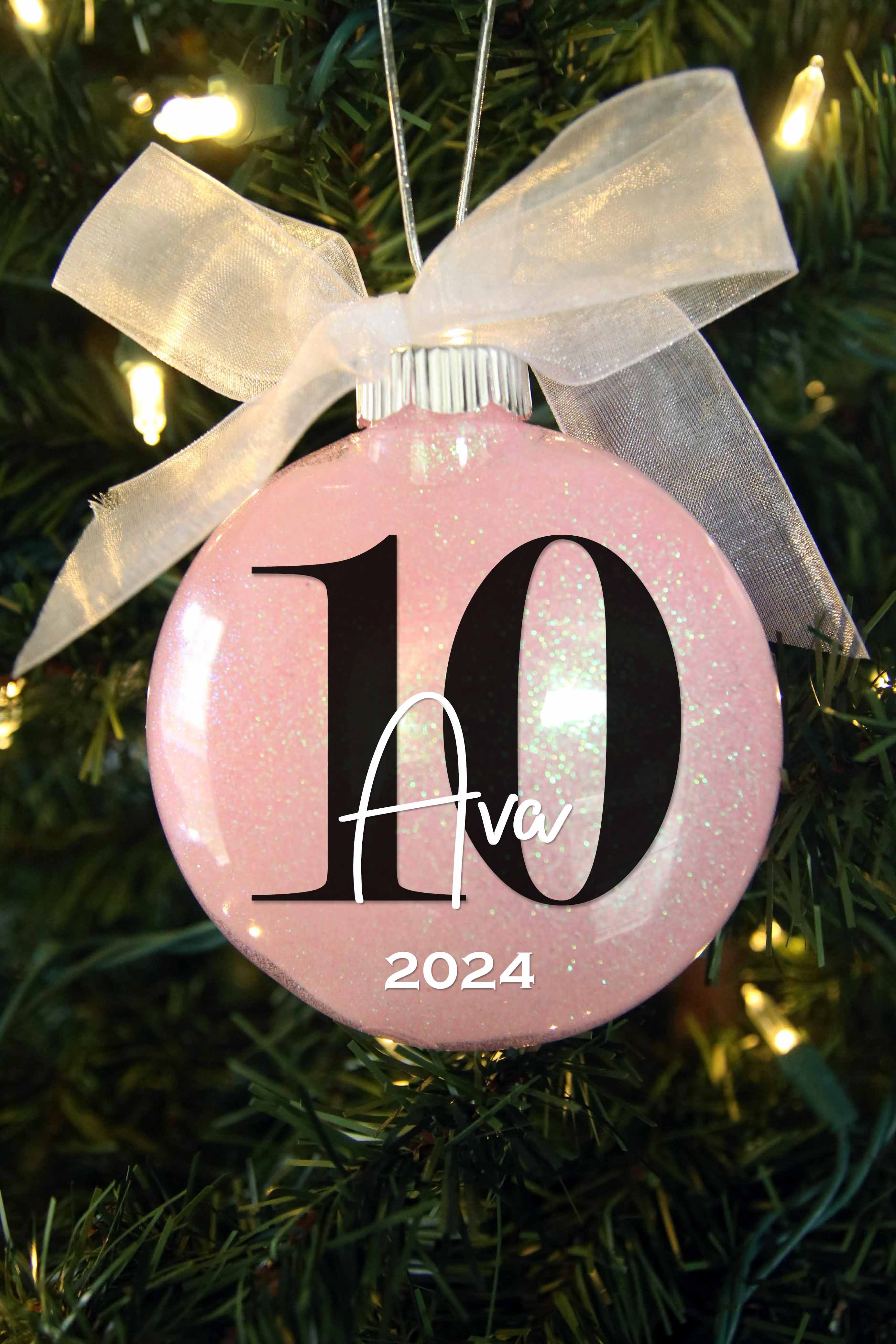 10 birthday ornament personalized with a name and year, and featured in light pink glitter