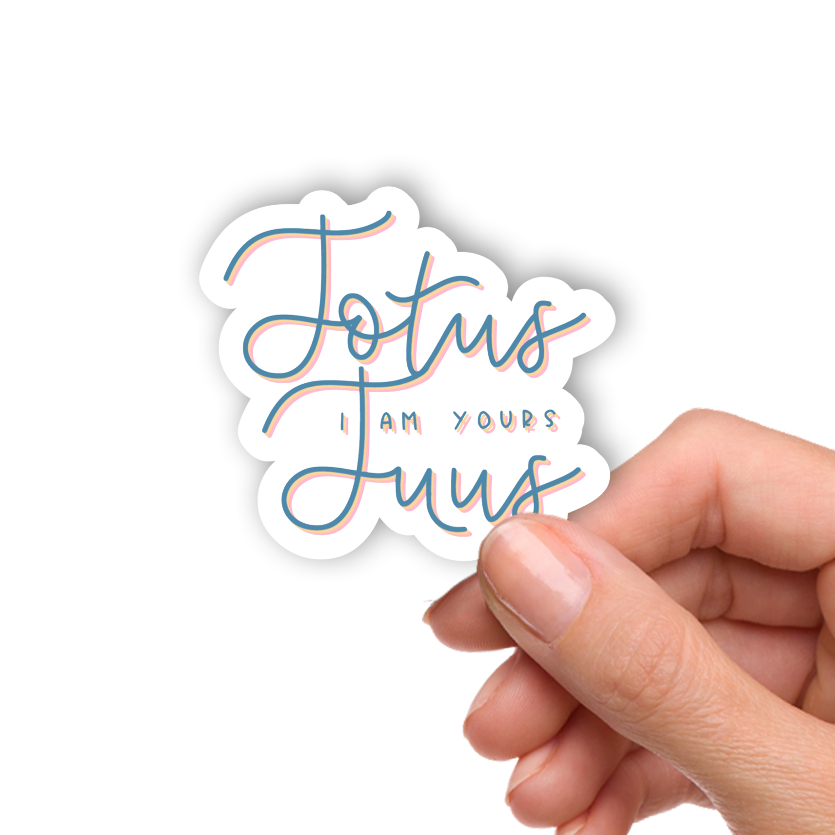 Hand holding a sticker with 'Totus Tuus I am yours' text on a white background