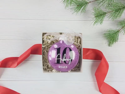 Unboxing video of orchid colored 10 Double Digits Birthday Gift - Personalized Glitter Christmas Ornament – Ten Year Keepsake - Custom Name Ornament
